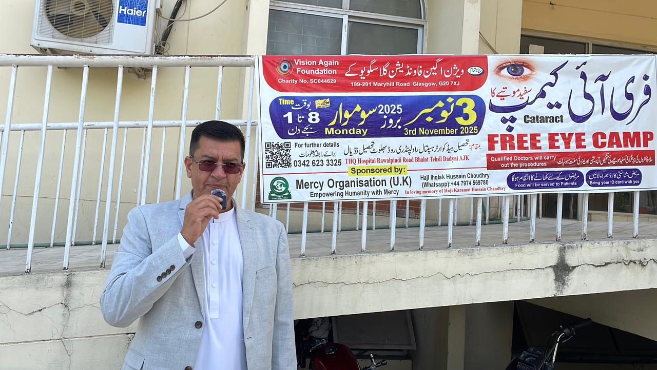 A volunteer speaking to the community about a free eye camp